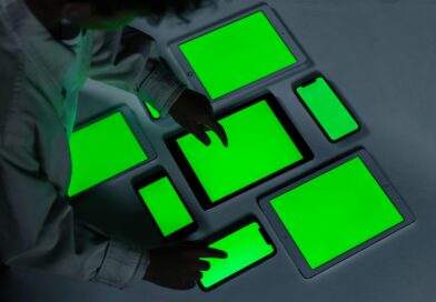 A variety of electronic gadgets with green screens being interacted with indoors.